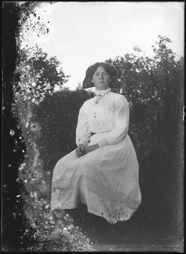 Young Woman Seated Amongst Trees