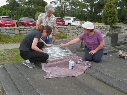 Cleaning headstone at Ashhurst Cemetery