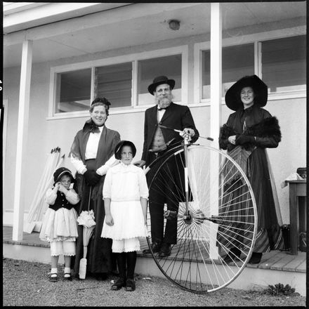 [Group in old fashioned clothes and pennyfarthing]