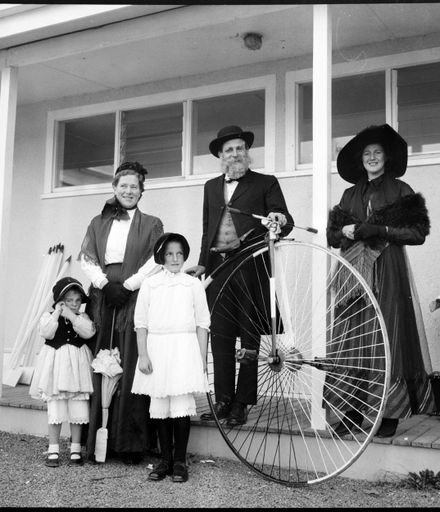 [Group in old fashioned clothes and pennyfarthing]