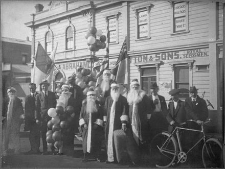 Father Christmases preparing to distribute presents to children, Christmas Day