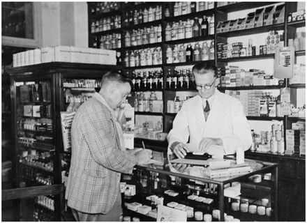 Evans Family Collection: Mr Evans in a Palmerston North pharmacy