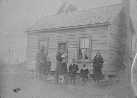 Mr and Mrs Peter Hansen and family outside their home