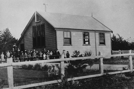 Teachers and pupils outside Tiritea School