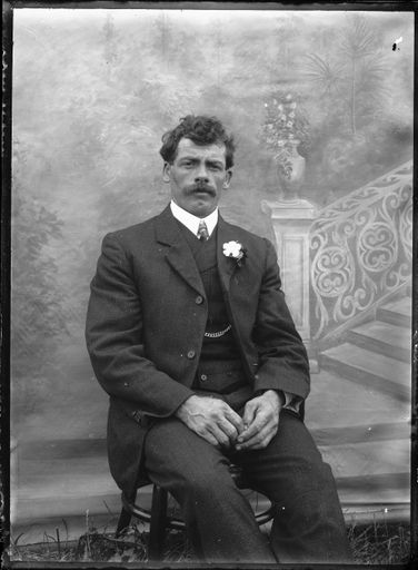 Portrait of Man in Front of Painted Backdrop