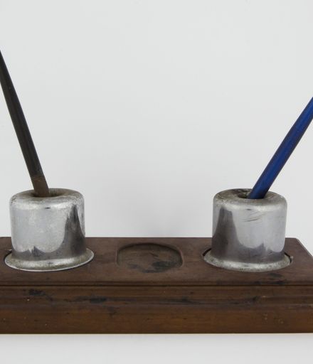 Two inkwells with wooden stand and three ink pens