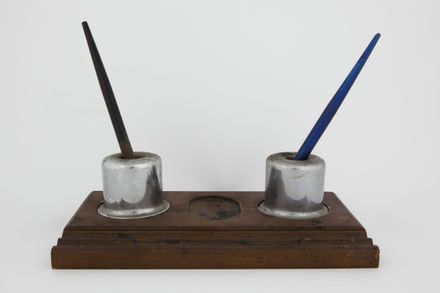 Two inkwells with wooden stand and three ink pens