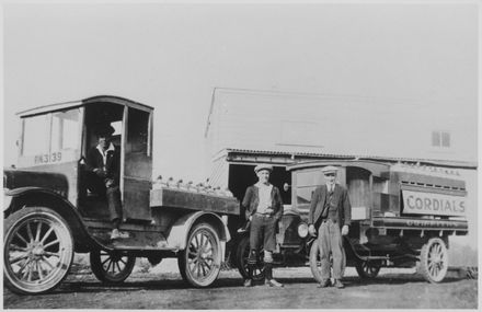 Delivery trucks and drivers outside Griffiths' Cordial Factory