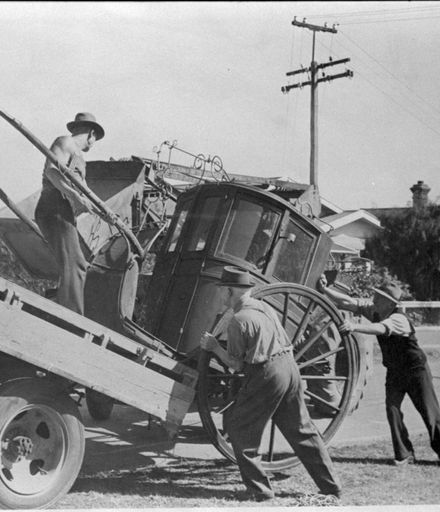 Loading a Hansom cab onto a truck