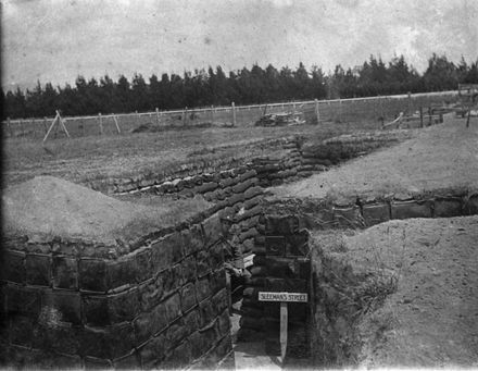 Soldier sits in mock trenches, Awapuni Racecourse