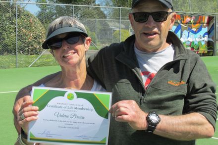 Valerie Brown receives her life membership certificate from president Graham Scott at Awapuni Tennis Club