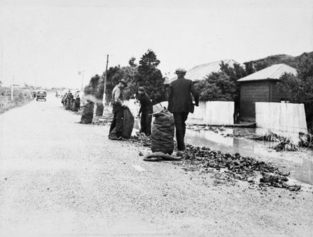 Bagging coke on the roadside after flood