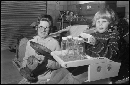 Unknown woman and child in garage - Resource cover image