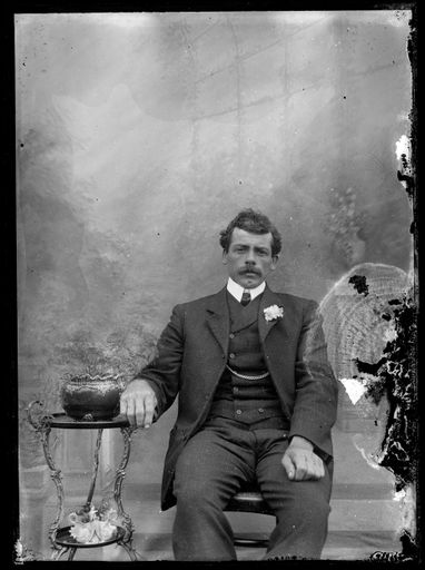 Portrait of Man in Front of Painted Backdrop