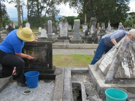 Cleaning headstones at Ashhurst Cemetery