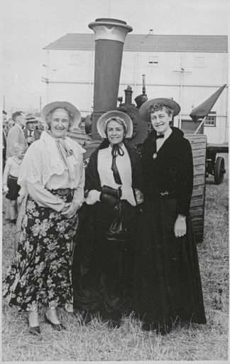 Three women in period costume, clebrating the 75th jubilee