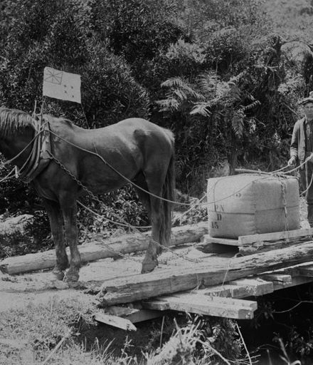 Henry Dittmer transporting a wool bale