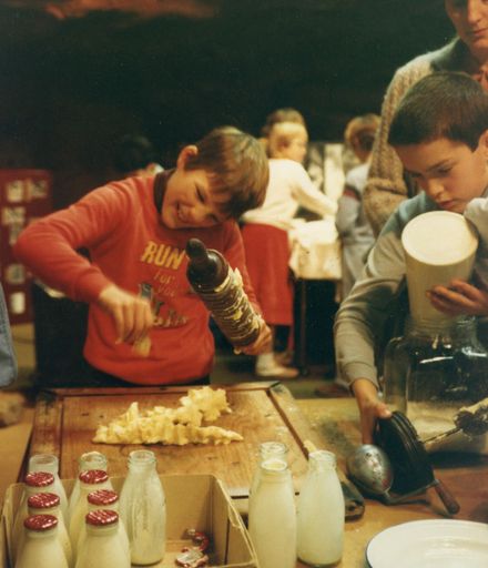 School pupil making Butter at the museum in Palmerston North
