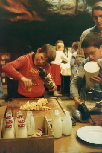 School pupil making Butter at the museum in Palmerston North