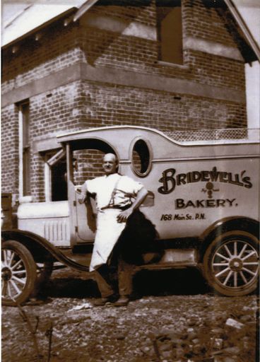 Reginald Bridewell with van in front of Bridewell's Bakery