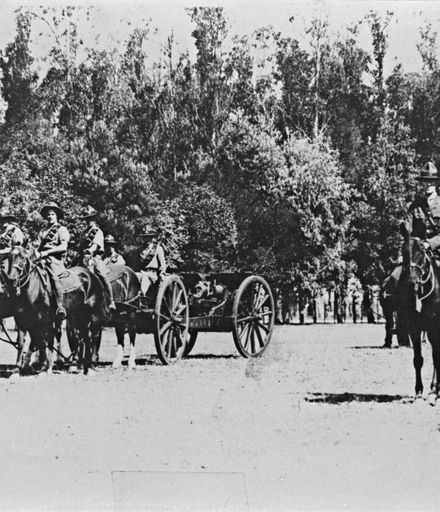 Troops on horseback, pulling a field gun.