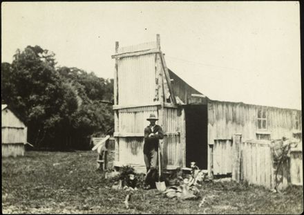 John Roots and dogs outside his whare
