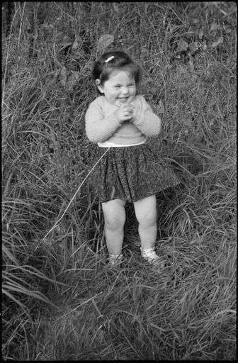 Toddler standing in the grass