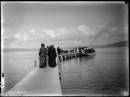 Figures Walking Down Dock Towards Boat