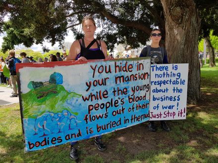Peace Action Manawatū - Protestors with signs