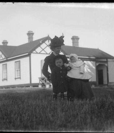Woman and Children Outside House