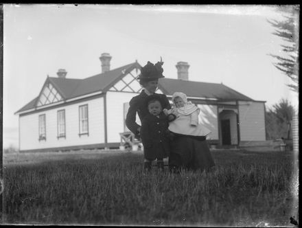 Woman and Children Outside House