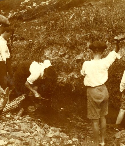 Boys hunting eels in stream, Fitzherbert West