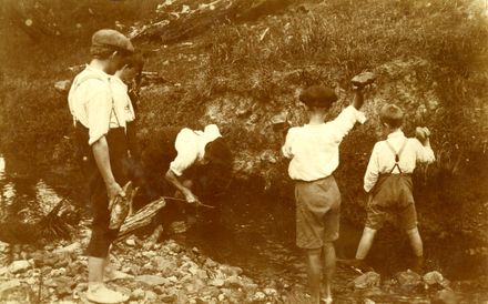 Boys hunting eels in stream, Fitzherbert West