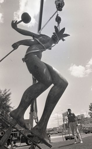 'Palmerston North sculptor Paul Dibble's bronze work Pacific Monarch is hoisted into place at the Manawatu Art Gallery'