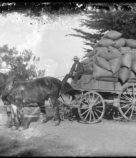Man Driving Loaded Horse and Cart