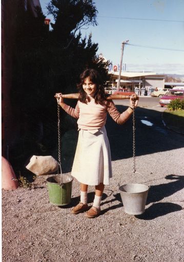 School pupil carrying milk pails at the museum in Palmerston North