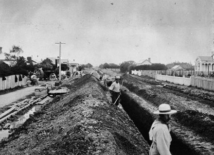 Workmen pumping trenches
