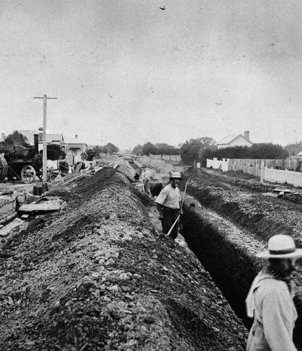 Workmen pumping trenches
