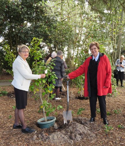 Robyn Tillman and Blanche Lauridson, helping to plant a "Kate Sheppard" camellia to mark Sufffrage 125