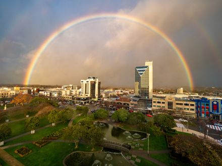 City skyline under rainbow
