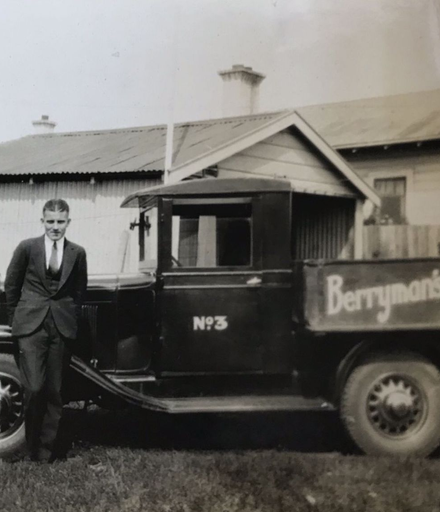 Walter Rumsey in front of delivery truck for Berryman's Radio and Music Shop.
