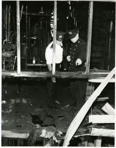 Fire Service Examine Scene of Fire