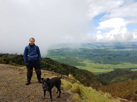 Evan Greensides on top of Wharite Peak with Blue