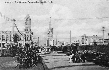 Man walking dogs in the central portion of The Square