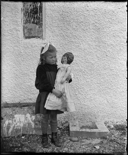 Unknown girl and her cloth doll - Resource cover image