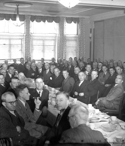 Group of men at luncheon