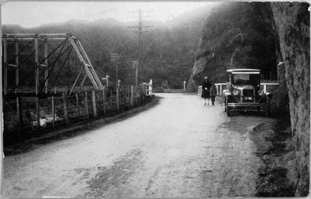 Woman, child and car on road at Ballance Bridge