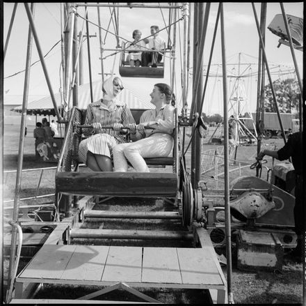 [Two Young Women Seated on the Ferris Wheel Fairground Attraction] - Resource cover image