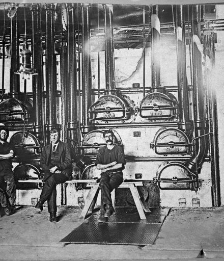 Workers seated beside gas retorts at the Palmerston North Gasworks