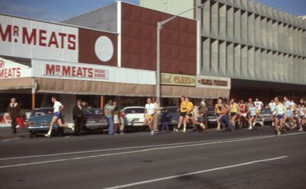 Runner Passing the Buildings on the South Side of the Square